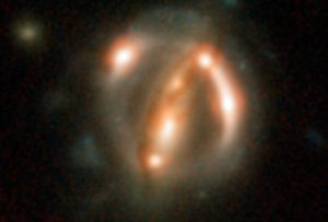 Bright arcs: Hubble Stace Telescope image of a distant quasar that has been gravitationally lensed. This image was part of this latest study. (Credits: ESA/Hubble/NASA/Suyu et al)
